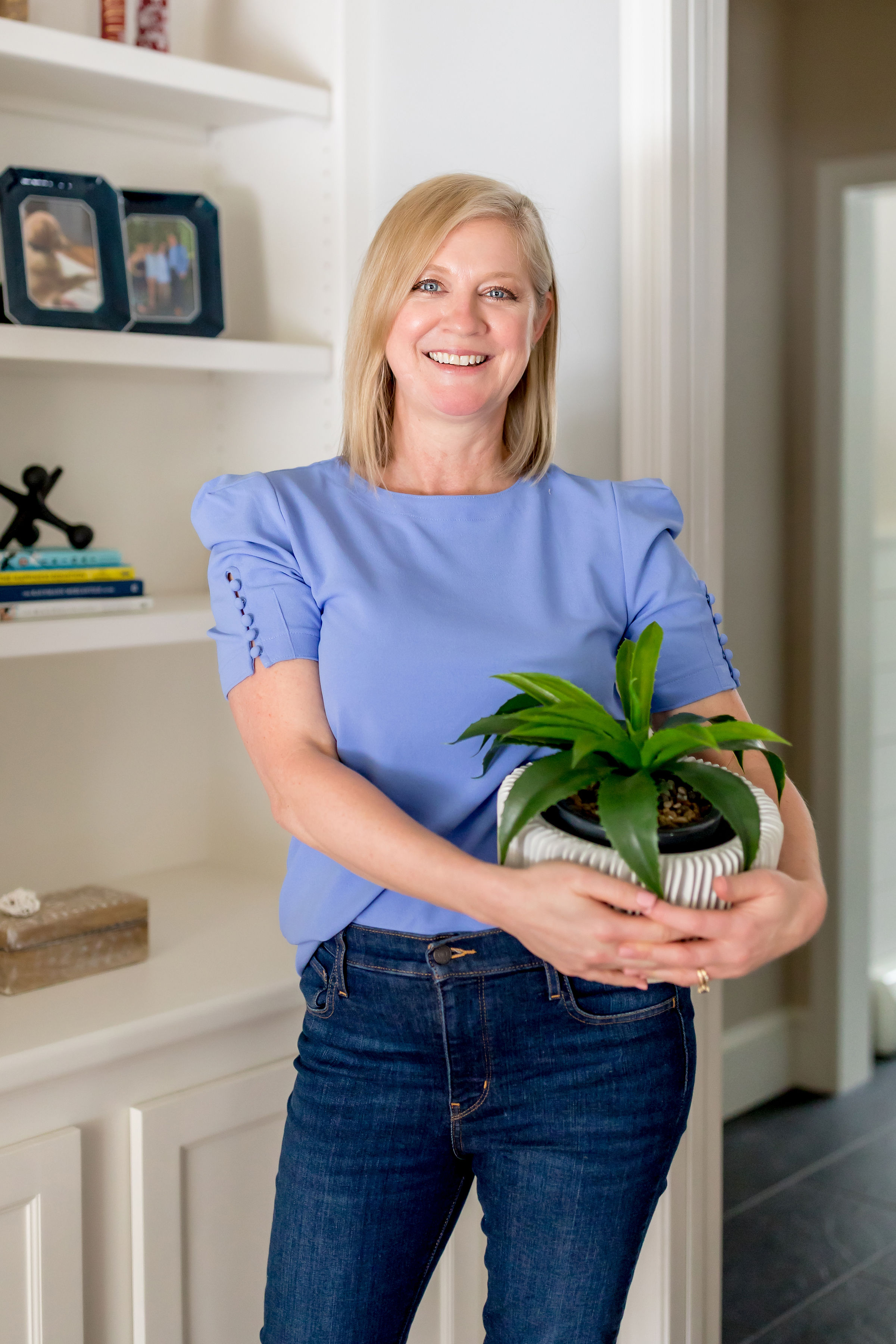 Lori Fischer holding plant, home staging business tips, ideal client tips