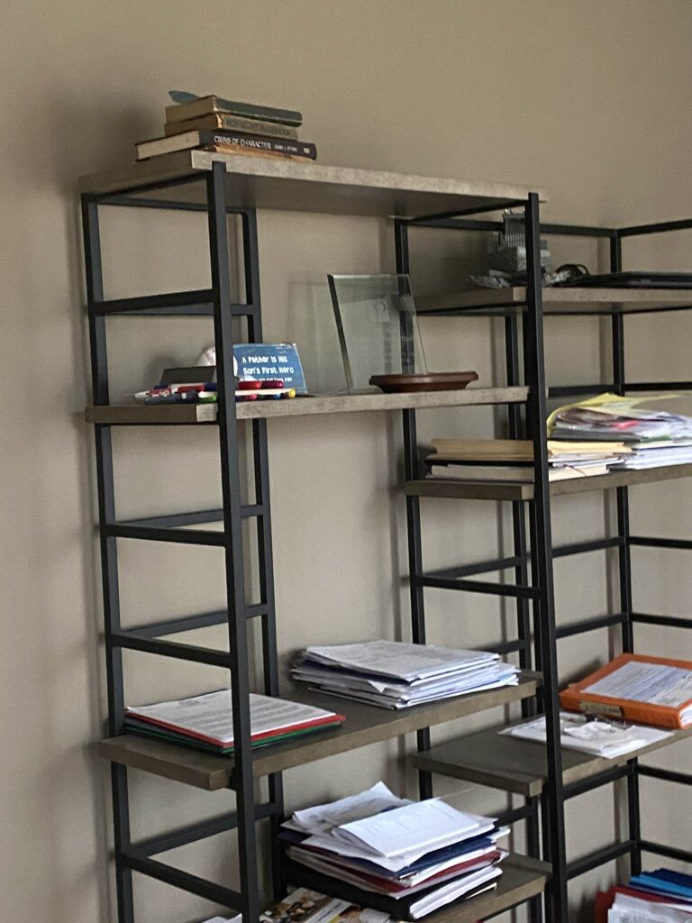 open shelving with paperwork in home office