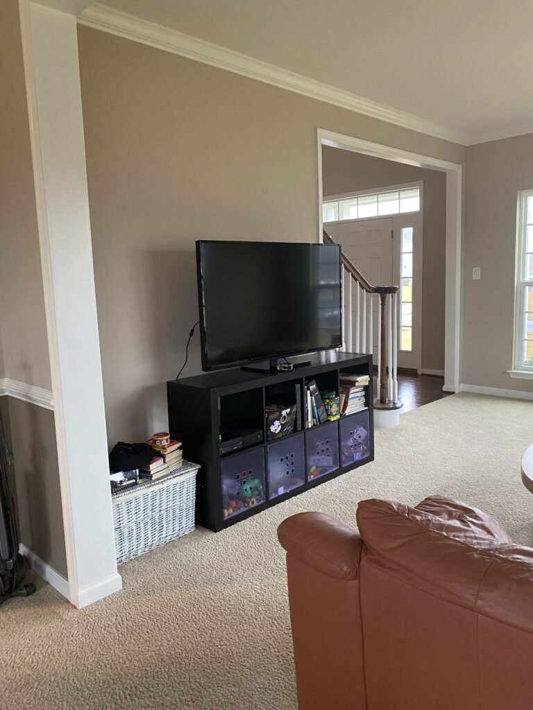 living room with entertainment center and toy bins, Tricks To Stage Any House Perfectly