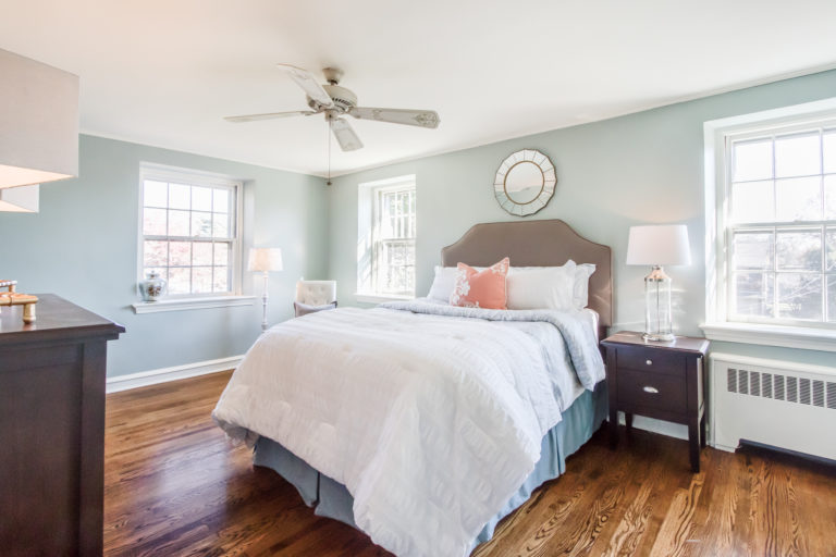 professionally staged bedroom with bedside table and lamp, Mix nightstands and lamps