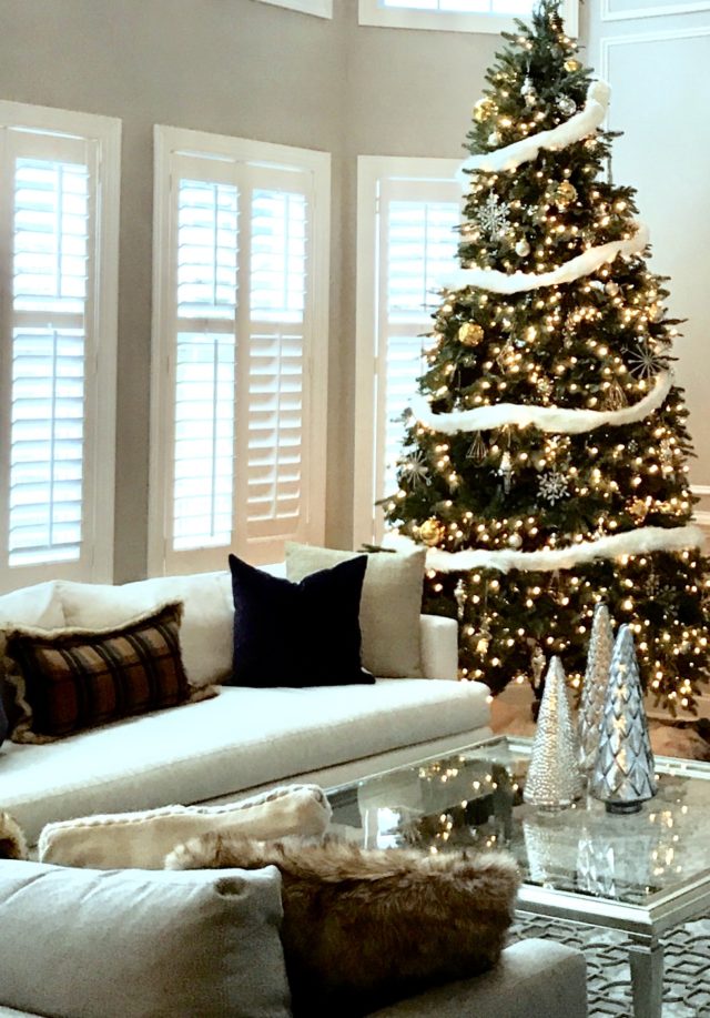 Christmas tree in living room decorated with holiday decor