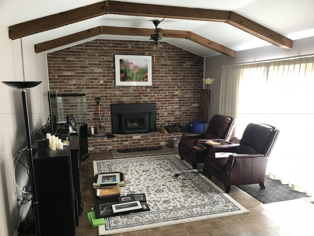 family room with brick wall and fireplace styling by rethink home interiors, transformation of a Listing