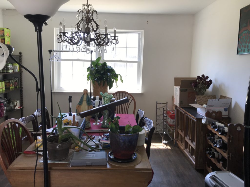 dining room with cluttered items on table