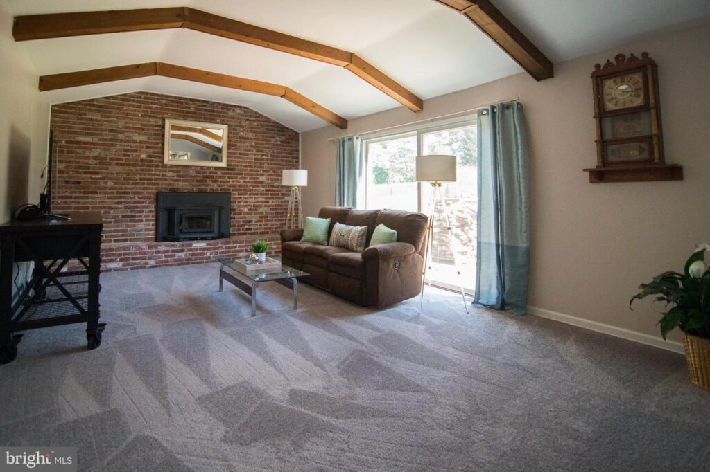 family room with brick wall and fireplace after styling by rethink home interiors