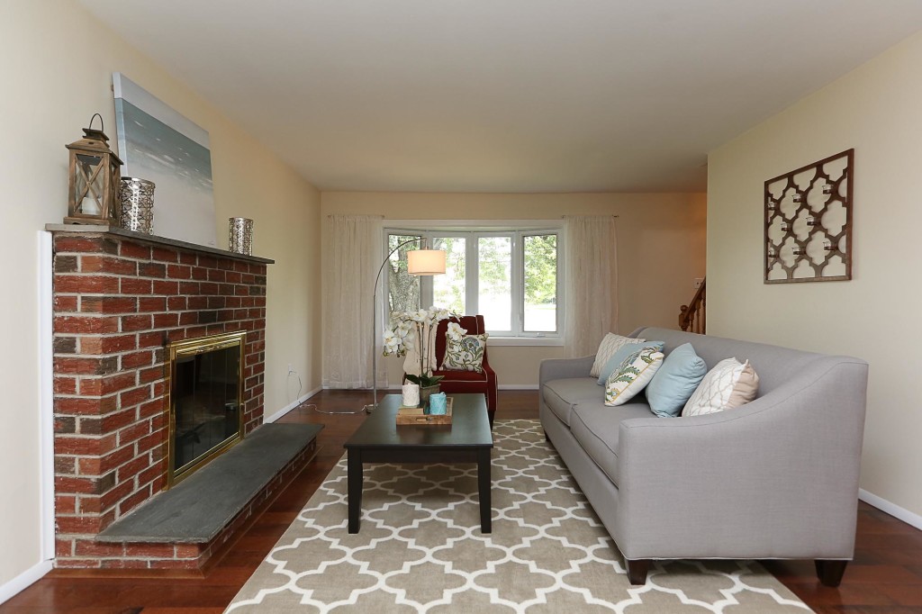 Brick fireplace with coffee table and gray couch