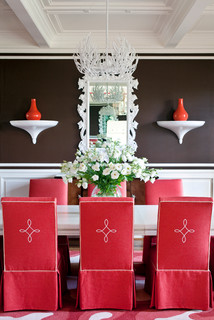 eclectic dining room with red chairs