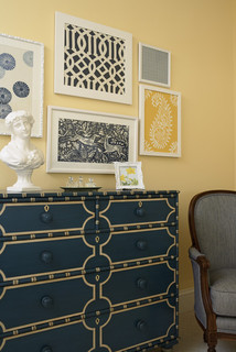 contemporary bedroom with navy and yellow dresser